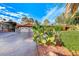 Front view of a home with a two-car garage and desert landscaping at 6640 Palmyra Ave, Las Vegas, NV 89146