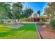 Landscaped front yard with large tree and artificial turf at 6640 Palmyra Ave, Las Vegas, NV 89146