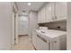 Bright laundry room with washer, dryer and extra storage at 6640 Palmyra Ave, Las Vegas, NV 89146