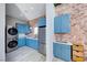 Laundry room with blue cabinets and modern appliances at 6640 Palmyra Ave, Las Vegas, NV 89146