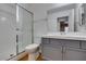 Well-lit bathroom with a shower, toilet, sink, and vanity at 7233 Eaglegate St, Las Vegas, NV 89131