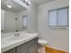 Bathroom featuring vanity, sink, and a tiled shower with glass doors at 7233 Eaglegate St, Las Vegas, NV 89131