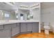 Bright bathroom with double sinks, large mirrors, and tile flooring at 7233 Eaglegate St, Las Vegas, NV 89131