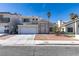 Charming two-story home featuring a well-maintained lawn, palm trees, and a two-car garage at 7233 Eaglegate St, Las Vegas, NV 89131