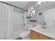 Bathroom with tub shower combo and stained wood vanity at 7490 Thistle Poppy St, Las Vegas, NV 89139