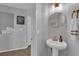 Small bathroom with pedestal sink and gold accents at 7490 Thistle Poppy St, Las Vegas, NV 89139