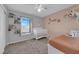 Bedroom with crib and neutral color palette at 7490 Thistle Poppy St, Las Vegas, NV 89139