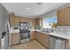 Modern kitchen with stainless steel appliances and light wood cabinets at 7490 Thistle Poppy St, Las Vegas, NV 89139