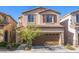 Two-story house with brown garage door and landscaping at 7638 Peaceful Trellis Dr, Las Vegas, NV 89179