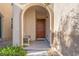 Front entry with arched entryway and a bench at 7638 Peaceful Trellis Dr, Las Vegas, NV 89179