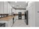 Kitchen with white cabinets and granite countertops at 7638 Peaceful Trellis Dr, Las Vegas, NV 89179