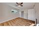 Bright bedroom with wood-look floors, ceiling fan, and built-in shelving at 801 7Th St, Boulder City, NV 89005