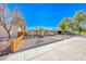 Single story home with a spacious front yard, gravel landscaping, and wooden fence at 801 7Th St, Boulder City, NV 89005