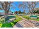 Paved pathway winds through a park with benches and mature trees at 801 7Th St, Boulder City, NV 89005