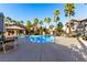 Community pool with surrounding patio furniture at 8250 N Grand Canyon Dr # 2073, Las Vegas, NV 89166