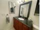 Bathroom featuring a wood vanity and a large mirror, enhancing the room's appeal at 833 Aspen Peak Loop # 1014, Henderson, NV 89011