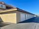 Row of garages with white doors and stucco exterior at 833 Aspen Peak Loop # 1014, Henderson, NV 89011