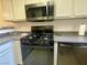 Compact kitchen with a stainless steel microwave and gas stove at 833 Aspen Peak Loop # 1014, Henderson, NV 89011