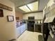 Well-lit kitchen with gray countertops and white cabinets at 833 Aspen Peak Loop # 1014, Henderson, NV 89011