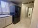 Kitchen area with stainless steel refrigerator and adjacent hallway at 833 Aspen Peak Loop # 1014, Henderson, NV 89011