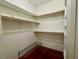 Spacious walk-in closet with wooden shelves, hanging rods, and wooden floor at 833 Aspen Peak Loop # 1014, Henderson, NV 89011