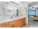 Double vanity bathroom with a shower and view into bedroom at 8600 Copper Falls Ave, Las Vegas, NV 89129