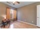 Well-lit bedroom featuring wood flooring and a window with curtains at 8600 Copper Falls Ave, Las Vegas, NV 89129