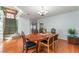 Dining room with hardwood floors, oval table, and access to stairs at 8600 Copper Falls Ave, Las Vegas, NV 89129