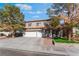 Two-story house with a three-car garage and manicured lawn at 8600 Copper Falls Ave, Las Vegas, NV 89129