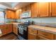 Modern kitchen with stainless steel appliances and wood cabinets at 8600 Copper Falls Ave, Las Vegas, NV 89129