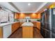 Kitchen with wood cabinets, an island, and stainless steel appliances at 8600 Copper Falls Ave, Las Vegas, NV 89129