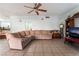 Living room features a large sectional sofa and ceiling fan at 8600 Copper Falls Ave, Las Vegas, NV 89129