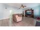 Spacious living room with tiled floors, ceiling fan and large TV at 8600 Copper Falls Ave, Las Vegas, NV 89129