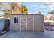 Tan wooden storage shed in backyard at 8600 Copper Falls Ave, Las Vegas, NV 89129