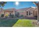 Landscaped backyard with patio and grassy area at 8608 Millsboro Dr, Las Vegas, NV 89134