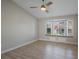 Bedroom with wood-look floors, ceiling fan and window seat at 8608 Millsboro Dr, Las Vegas, NV 89134