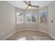 Bright bedroom with wood-look floors, ceiling fan, and bay window at 8608 Millsboro Dr, Las Vegas, NV 89134