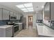 Modern kitchen with gray cabinets, quartz countertops, and stainless steel appliances at 8608 Millsboro Dr, Las Vegas, NV 89134