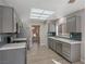 Modern kitchen with gray cabinets, quartz countertops, and stainless steel appliances at 8608 Millsboro Dr, Las Vegas, NV 89134