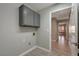 Laundry room with upper cabinets and view to another room at 8608 Millsboro Dr, Las Vegas, NV 89134