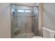 Walk-in shower with gray tile, built-in seat and glass enclosure at 8608 Millsboro Dr, Las Vegas, NV 89134