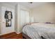 Cozy bedroom with a queen bed, mirrored closet doors and wood floors at 8896 Dove Cove Dr, Las Vegas, NV 89129