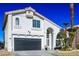 Two-story house with a black garage door and landscaping at 8896 Dove Cove Dr, Las Vegas, NV 89129