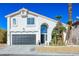 Two story house, white exterior, and a three car garage at 8896 Dove Cove Dr, Las Vegas, NV 89129