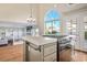 Kitchen island with cooktop and view into living room at 8896 Dove Cove Dr, Las Vegas, NV 89129