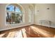 Sunlit living room featuring hardwood floors and an arched window at 8896 Dove Cove Dr, Las Vegas, NV 89129