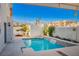 Inviting backyard pool with waterfall feature and patio cover at 8896 Dove Cove Dr, Las Vegas, NV 89129