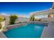 Relaxing pool area with tiled accents and a pergola at 8896 Dove Cove Dr, Las Vegas, NV 89129