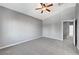 Bright bedroom featuring carpet, ceiling fan, and access to hallway at 9104 Little Horse Ave, Las Vegas, NV 89143