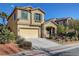 Beige two-story house with a two-car garage and mature landscaping at 9104 Little Horse Ave, Las Vegas, NV 89143